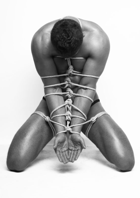 man-in-rope-kneeling